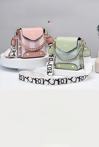 Detail of pleated design texture on mini crossbody bags with wide fabric straps
