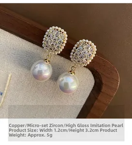 Detail of Korean style zircon earrings with pearls showing 1.2x3.2cm size and texture