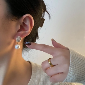 Elegant Korean style pearl drop earrings with rectangular zircon studs on female model