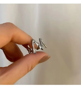 Detailed view of silver irregular wavy ring with modern minimalist molten design