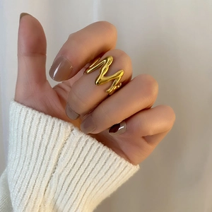 Minimalist M-shaped 18K gold plated stainless steel ring with fluid lava texture design