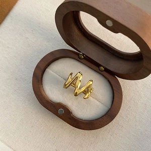 Golden M-shaped irregular wave ring in 18K gold plated steel with wooden jewelry box