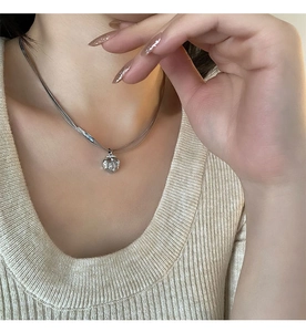 Double-layered silver shell pendant necklace with snake chain and delicate link detail