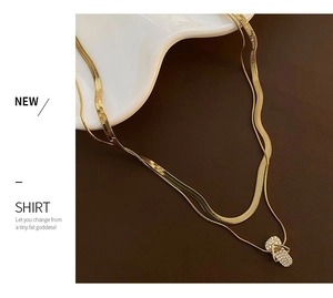 Detail of gold double-layer necklace with micro-pave mini flip-flop pendant and snake chain