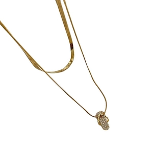 Gold double-layered necklace set featuring herringbone chain and crystal flip-flop pendant
