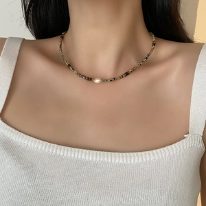 Baroque pearl and tiger eye stone beaded choker necklace on model for elegant look