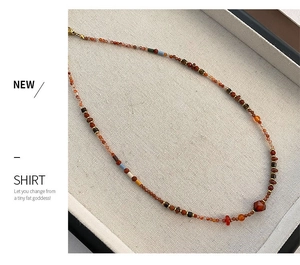 Detailed view of colorful red agate and Czech beads on a retro style necklace