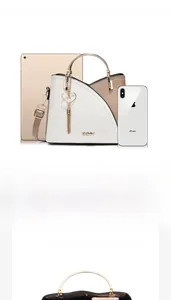 Spacious interior of bicolor leather handbag showing capacity for iPad and phone