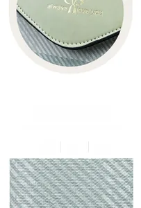 Detail of light green PU leather bag featuring gold lettering and bow pattern design