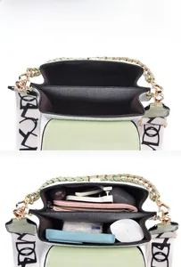 Detail view of the two spacious main compartments inside this light green crossbody bag