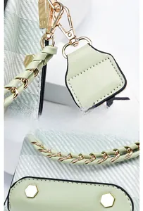 Detail of mint green leather mini bag with gold-plated detachable lobster clasp hardware