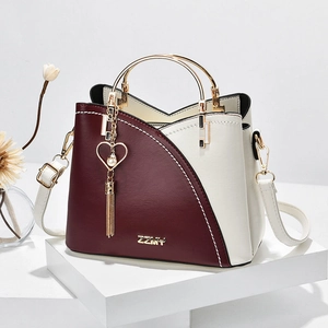 Fashionable burgundy and cream leather tote bag with elegant V-shape color block design