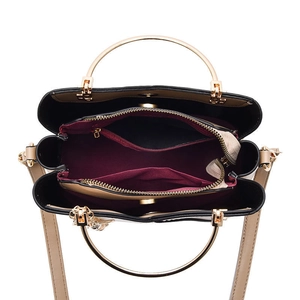 Chic beige and black tote bag with gold ring handles and red interior storage compartments