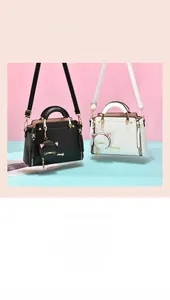 Detail of elegant handbags featuring cute cartoon cat charm and metallic zipper accents