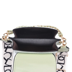 Light green mini crossbody bag with graffiti strap and chain shown in open interior view