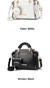 Detail of white and black faux leather handbags with cute cat charms and metal logo