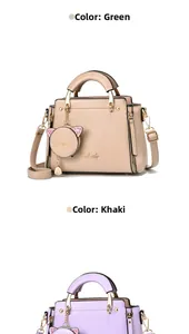 Detail of elegant handbags with cat-shaped coin purse charms and gold metal handles