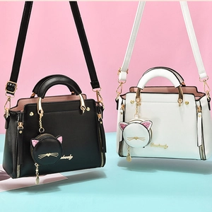 Chic cat-themed handbag set in black and cream PU leather with gold ring handles