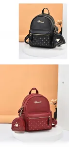 Detail of lychee textured leather mini backpack with gold rivets and quilting