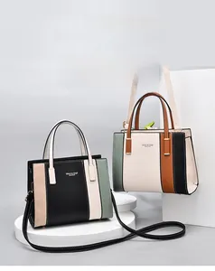 Close-up of retro color-block handbags with structured top handles and shoulder straps