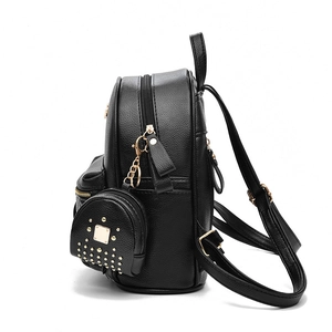 Fashionable black leather backpack with gold rivets and matching small round pouch