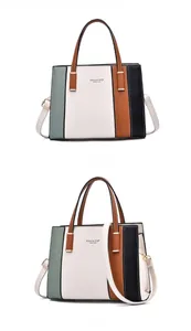 Detail view of large color-block handbag with gold hardware and logo embossing