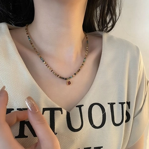 Natural stone and pearl beaded necklace with red zircon pendant in gold-plated steel