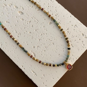 Natural stone beaded necklace with red gemstone pendant in gold plated titanium steel