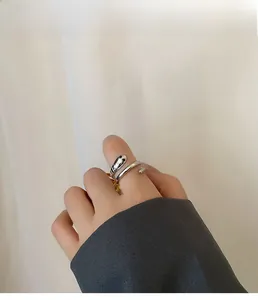 Close-up of minimalist silver snake ring with polished finish on model finger