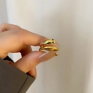 Vintage gold snake ring with green stone eyes and textured body for women