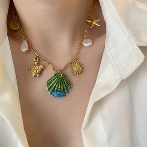 Golden paperclip chain necklace with sea shell, starfish, and baroque pearl charms