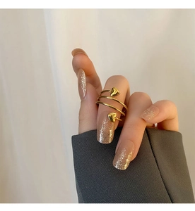 Close-up of a gold heart spiral ring showing the elegant multi-layer wrap design