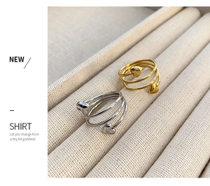 Macro shot of gold and silver heart wrap rings on soft velvet jewelry tray displays
