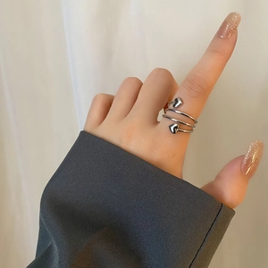 Minimalist spiral titanium steel ring with heart accents and polished silver finish