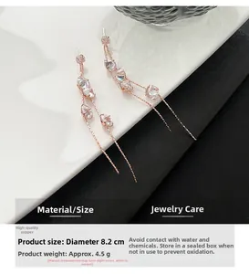 Macro shot of 8.2cm rose gold tassel earrings with pink zircons and size specifications
