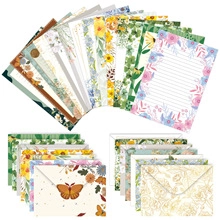 Macro view of floral stationery set with lined writing paper and elegant vintage envelopes