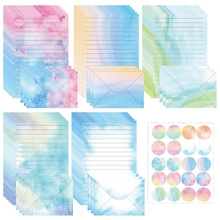 Macro detail of watercolor gradient stationery set with lined paper and matching envelopes