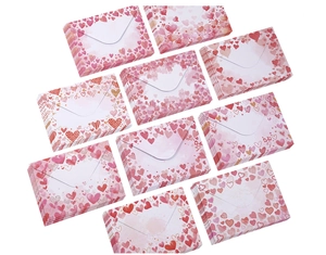Detailed view of pink and red heart-patterned envelopes with LOVE text for Valentine's Day