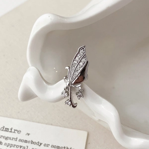 Detail of silver butterfly ear cuff with micro-pave cubic zirconia and dangling chains