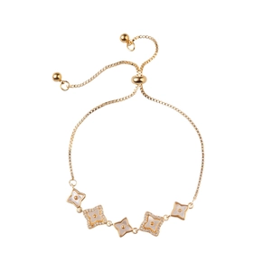 Adjustable gold clover bracelet featuring white shell inlays and sparkling zircon accents