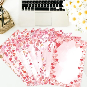 Pink heart-themed stationery set for Valentine letters with watercolor heart illustrations