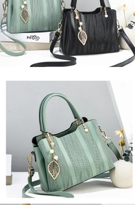 Close-up of matte PU leather tote with leaf pendant and streamline pattern details