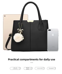 Detail of black pebbled leather tote bag capacity showing iPad and phone storage