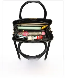 Internal structure of black lychee leather tote bag showing large capacity for daily items