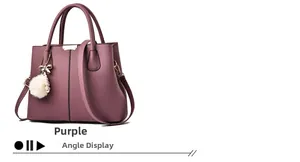 Detail of purple litchi grain handbag featuring plush ball and metal bow charm