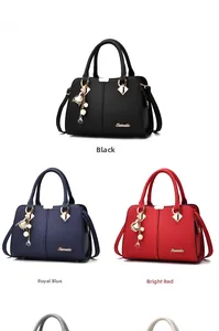 Detailed view of荔枝 texture leather handbag with floral charms in black, blue and red