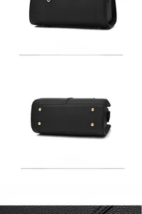 Detailed back and bottom view of black lychee leather handbag with gold protective studs