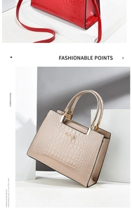 Detail of glossy crocodile pattern patent leather handbag with gold metal hardware accessories