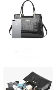 Detail view of black crocodile pattern tote bag with multi-layer interior storage capacity