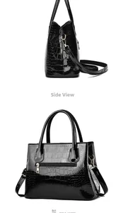 Side and back view of a glossy black crocodile pattern tote bag with gold hardware